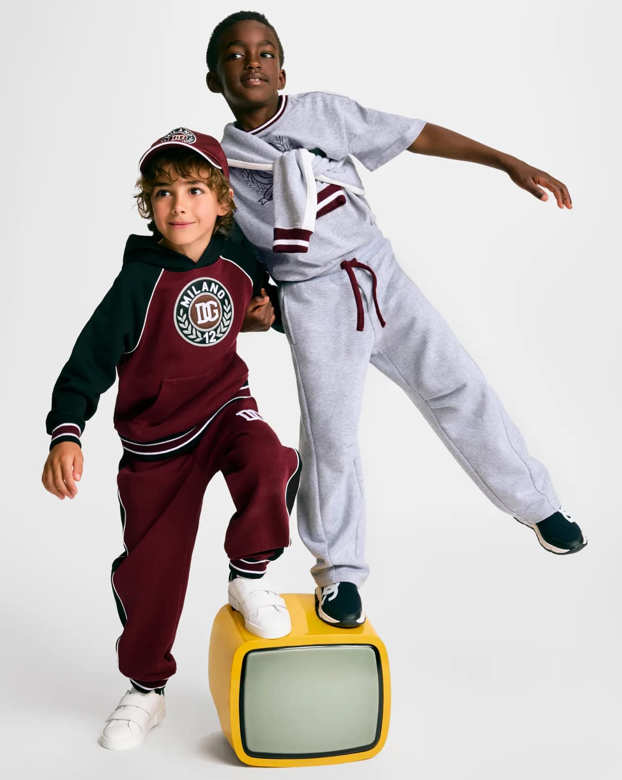 Two kids in sportswear posing dynamically